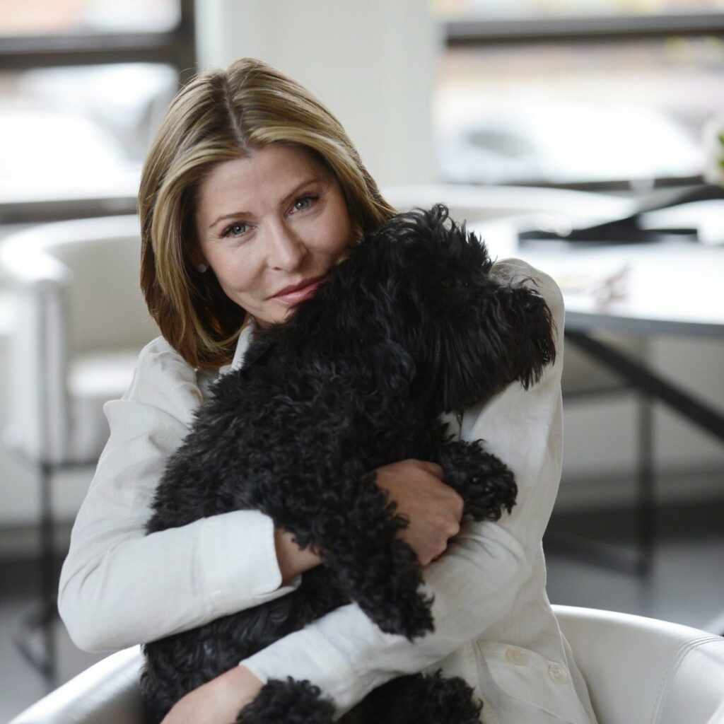 Kristin Hovencamp sitting in an office hugging her dog in her lap