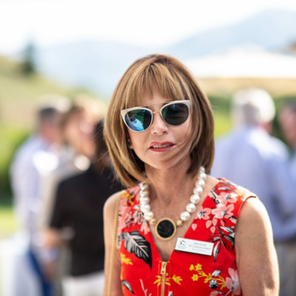 Maggie Sturdevant with sun glasses on enjoying an outdoor event in summery weather
